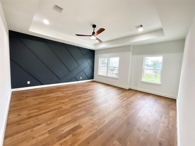 3038 Webster St, Houston, TX 77004 - empty room with visible vents, a raised ceiling, and wood finished floors