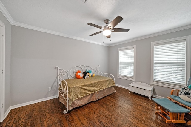 bedroom featuring baseboards, ceiling fan, wood finished floors, and crown molding