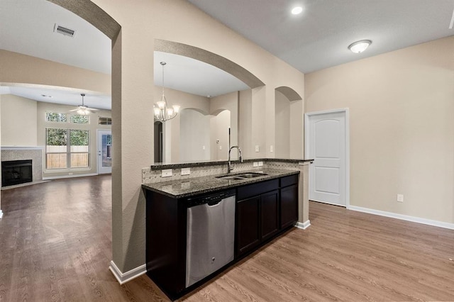 14356 N Summerchase Cir, Willis, TX 77318 - kitchen with stainless steel dishwasher, visible vents, ceiling fan, dark stone counters, and a sink