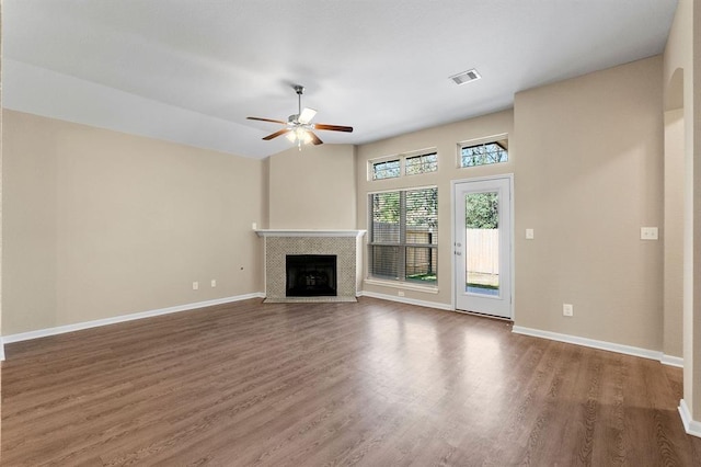 14356 N Summerchase Cir, Willis, TX 77318 - unfurnished living room featuring visible vents, wood finished floors, a fireplace, baseboards, and a ceiling fan