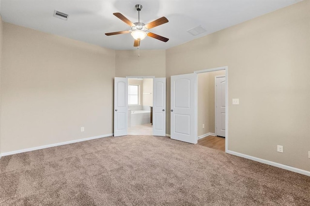 14356 N Summerchase Cir, Willis, TX 77318 - unfurnished bedroom featuring carpet flooring, baseboards, visible vents, and ensuite bath