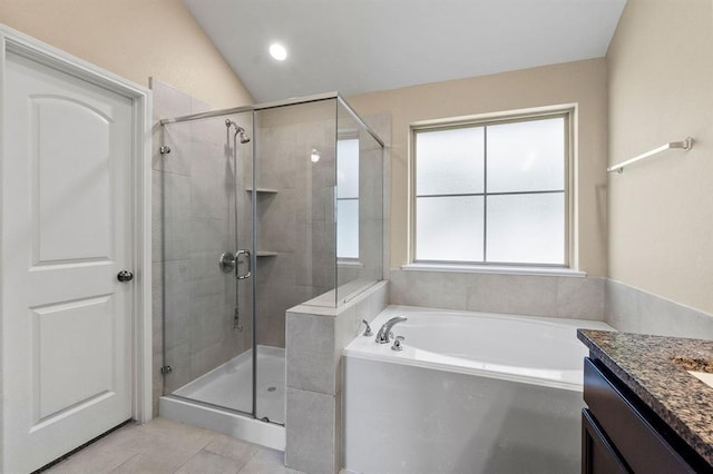 14356 N Summerchase Cir, Willis, TX 77318 - bathroom with a garden tub, tile patterned flooring, vaulted ceiling, a shower stall, and vanity