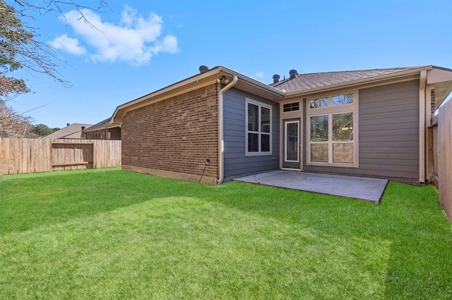 14356 N Summerchase Cir, Willis, TX 77318 - back of house with brick siding, a fenced backyard, a patio area, and a yard