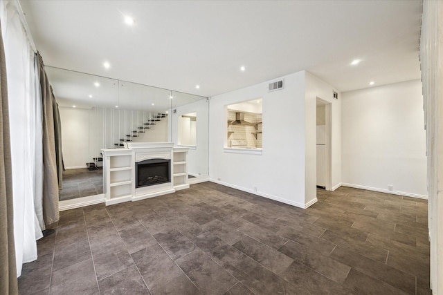 2503 Mccue Rd Unit 23, Houston, TX 77056 - unfurnished living room with recessed lighting, a fireplace, baseboards, and dark tile patterned flooring