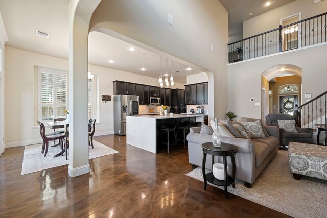19542 Juniper Breeze Ln, Spring, TX 77379 - living area featuring arched walkways, a healthy amount of sunlight, recessed lighting, and visible vents