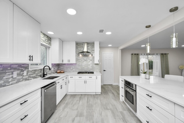 5510 Braesvalley, Houston, TX 77096 - kitchen featuring stainless steel appliances, a sink, wall chimney exhaust hood, light stone counters, and white cabinetry