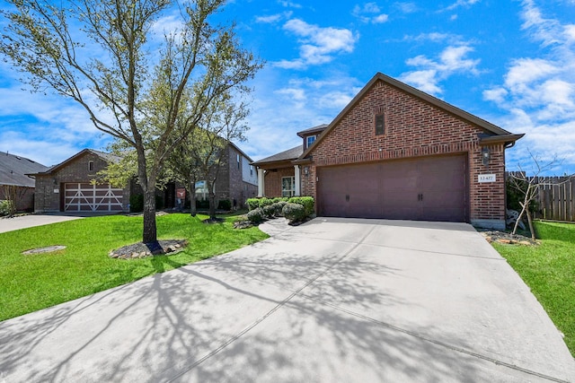 12427 Point Arbor Ct, Tomball, TX 77377 - ranch-style home featuring concrete driveway, fence, brick siding, an attached garage, and a front yard