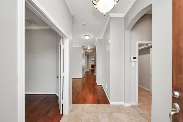 12427 Point Arbor Ct, Tomball, TX 77377 - hallway with arched walkways, wood finished floors, ornamental molding, and baseboards