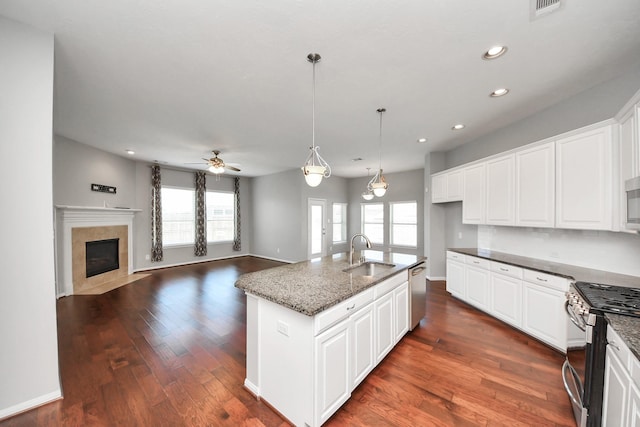 12427 Point Arbor Ct, Tomball, TX 77377 - kitchen featuring plenty of natural light, dark stone counters, stainless steel appliances, and a sink