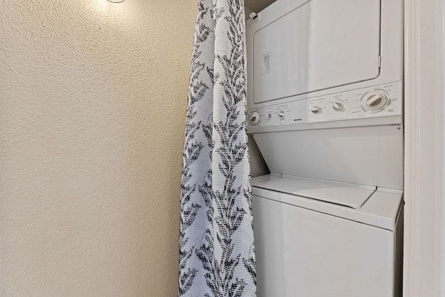 2323 Augusta Dr Unit 36, Houston, TX 77057 - laundry room featuring estacked washer and dryer and a textured wall