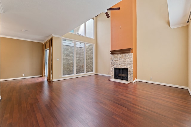 2323 Augusta Dr Unit 36, Houston, TX 77057 - unfurnished living room featuring dark wood-type flooring, a fireplace, crown molding, and baseboards