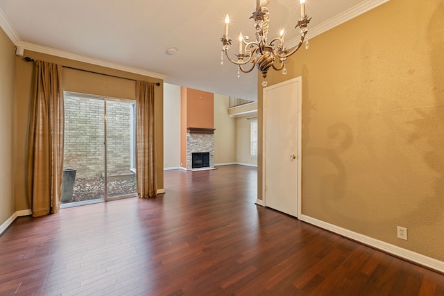 2323 Augusta Dr Unit 36, Houston, TX 77057 - unfurnished living room featuring a chandelier, dark wood-style flooring, healthy amount of natural light, ornamental molding, and a stone fireplace