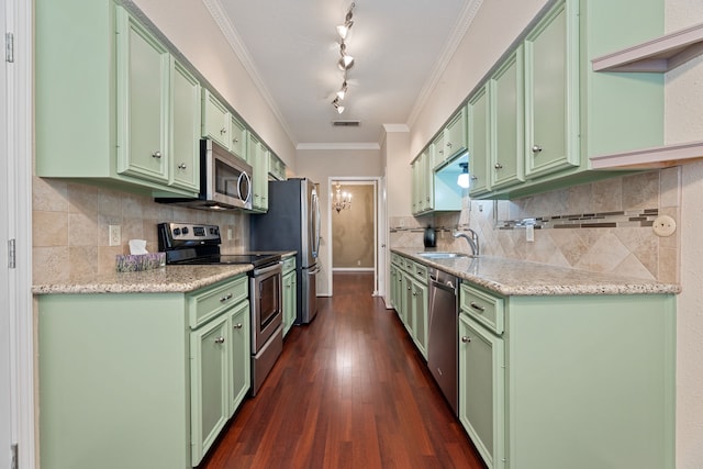 2323 Augusta Dr Unit 36, Houston, TX 77057 - kitchen featuring green cabinets, appliances with stainless steel finishes, a sink, dark wood finished floors, and ornamental molding