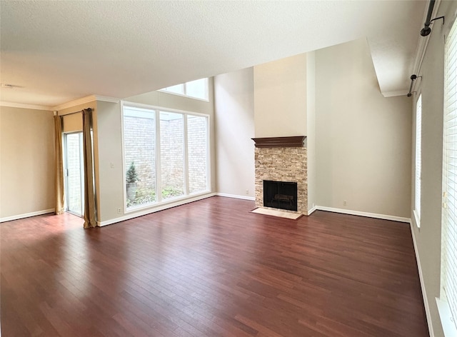 2323 Augusta Dr Unit 36, Houston, TX 77057 - unfurnished living room with dark wood-type flooring, a stone fireplace, and ornamental molding