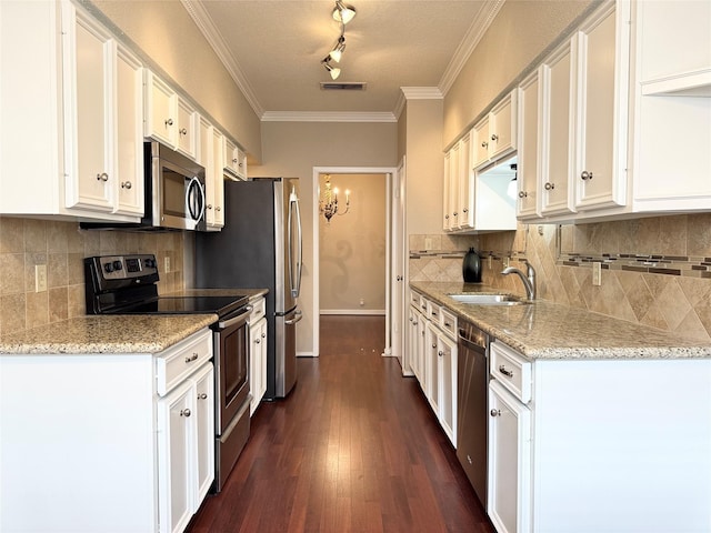 2323 Augusta Dr Unit 36, Houston, TX 77057 - kitchen featuring stainless steel appliances, white cabinets, ornamental molding, light stone countertops, and decorative backsplash