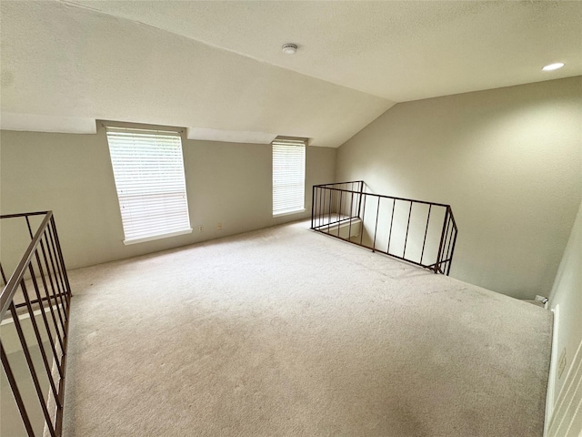 2323 Augusta Dr Unit 36, Houston, TX 77057 - additional living space with carpet flooring, vaulted ceiling, and a textured ceiling