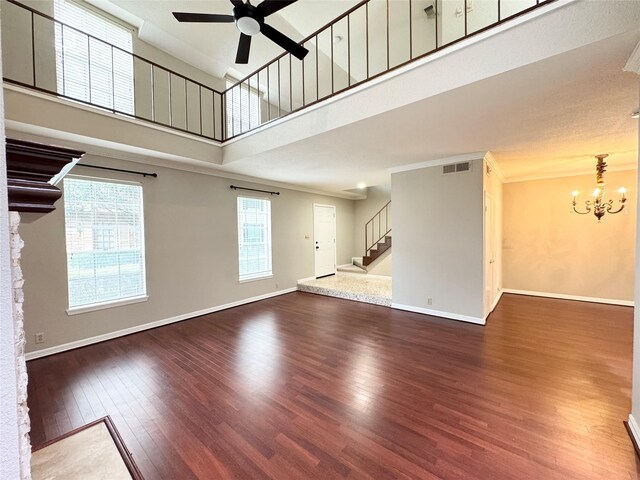 2323 Augusta Dr Unit 36, Houston, TX 77057 - unfurnished living room featuring a ceiling fan, stairway, dark wood-style floors, a chandelier, and a towering ceiling
