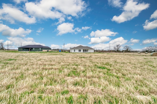 view of yard with a rural view