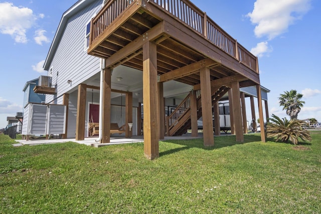 979 Sea Spray Dr, Crystal Beach, TX 77650 - exterior space with stairway, a lawn, and a patio area