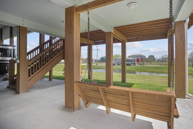 979 Sea Spray Dr, Crystal Beach, TX 77650 - view of patio featuring stairs and a water view