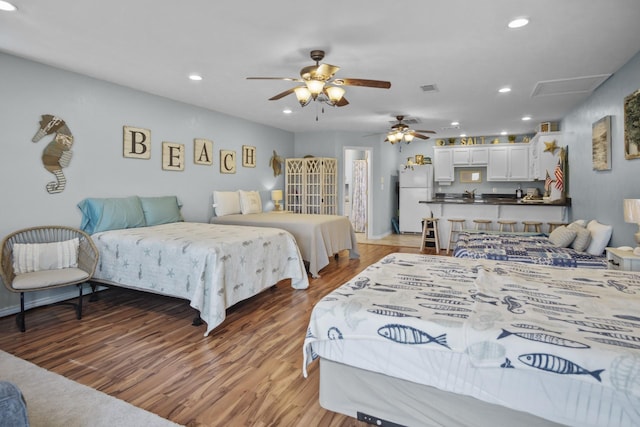 979 Sea Spray Dr, Crystal Beach, TX 77650 - bedroom featuring recessed lighting, light wood-style floors, and freestanding refrigerator