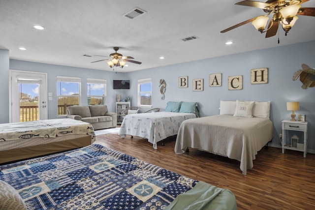 979 Sea Spray Dr, Crystal Beach, TX 77650 - bedroom with visible vents, multiple windows, wood finished floors, and access to outside