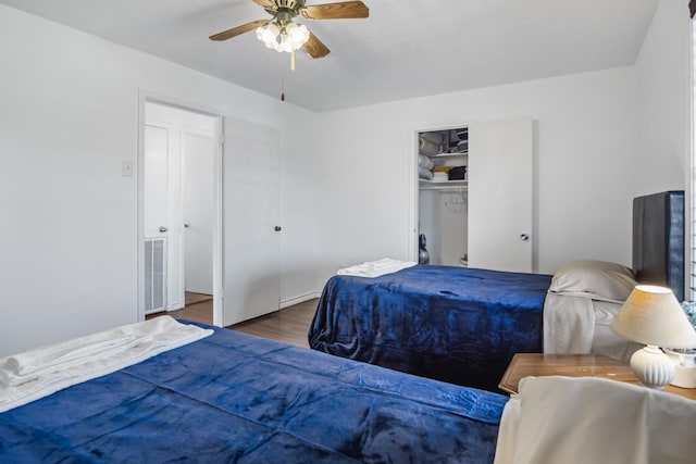 bedroom with visible vents, a closet, wood finished floors, and a ceiling fan
