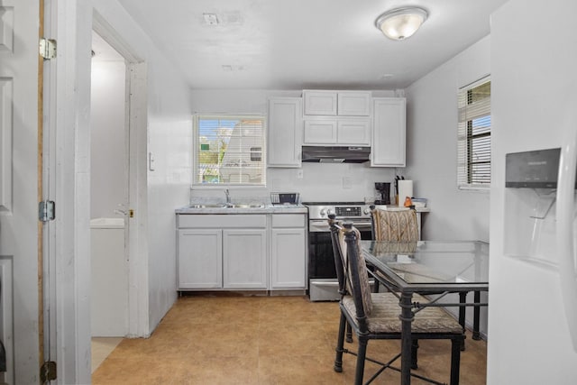 kitchen featuring under cabinet range hood, stainless steel electric stove, white cabinets, and a sink