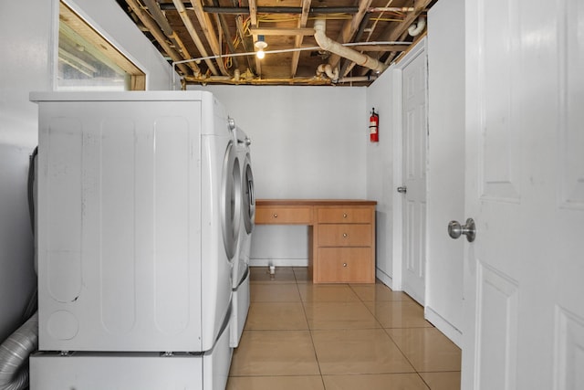 washroom featuring light tile patterned floors, laundry area, and separate washer and dryer
