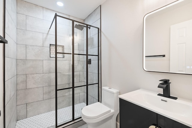 full bath with vanity, toilet, and a shower stall