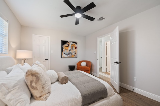 bedroom with visible vents, ceiling fan, baseboards, and wood finished floors