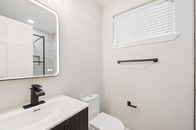 bathroom with a shower, toilet, and vanity