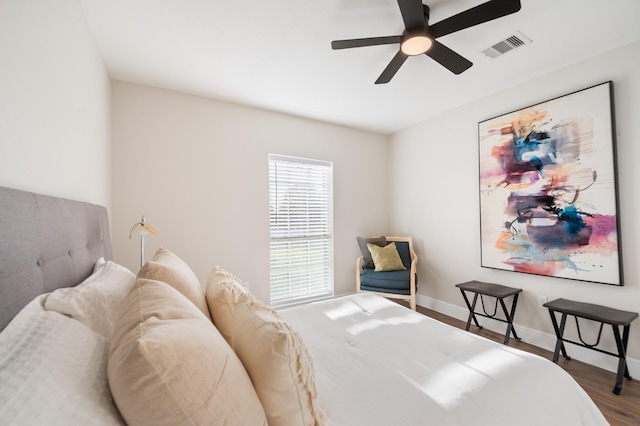 bedroom featuring visible vents, wood finished floors, baseboards, and ceiling fan