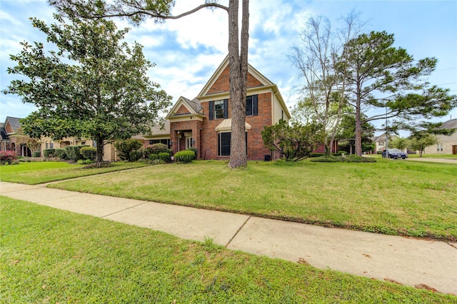 view of front of home with a front yard and brick siding