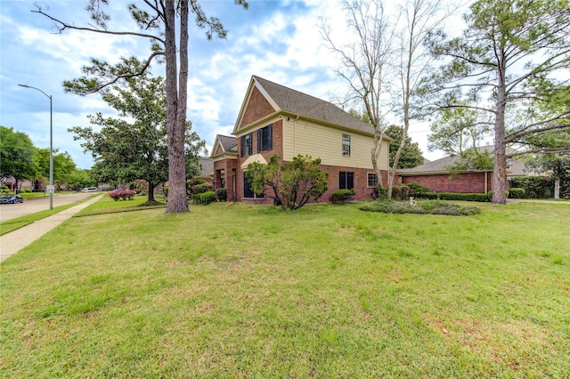 view of property exterior with brick siding and a lawn