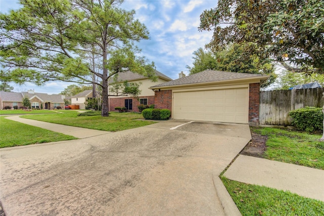 view of front of home featuring brick siding, fence, a garage, a front lawn, and concrete driveway