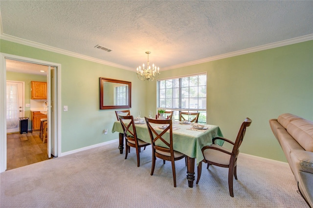 dining room featuring crown molding, visible vents, baseboards, light carpet, and a notable chandelier