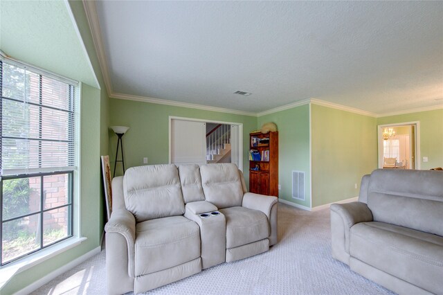 living room featuring carpet flooring, a notable chandelier, visible vents, and a healthy amount of sunlight