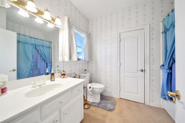 bathroom with vanity, curtained shower, toilet, and wallpapered walls