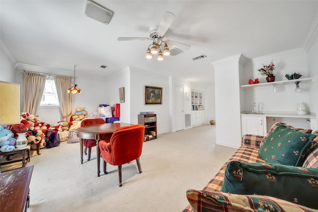 dining space featuring ceiling fan, visible vents, light carpet, and ornamental molding