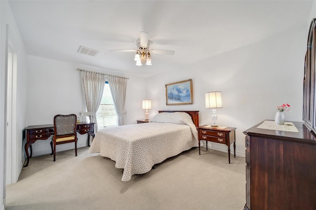 bedroom with visible vents, a ceiling fan, baseboards, and light colored carpet
