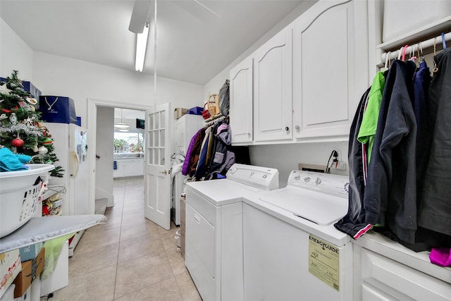 laundry area featuring cabinet space, light tile patterned flooring, french doors, and washer and clothes dryer