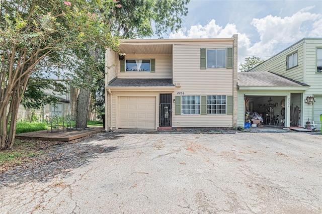 view of front of house with driveway and a shingled roof