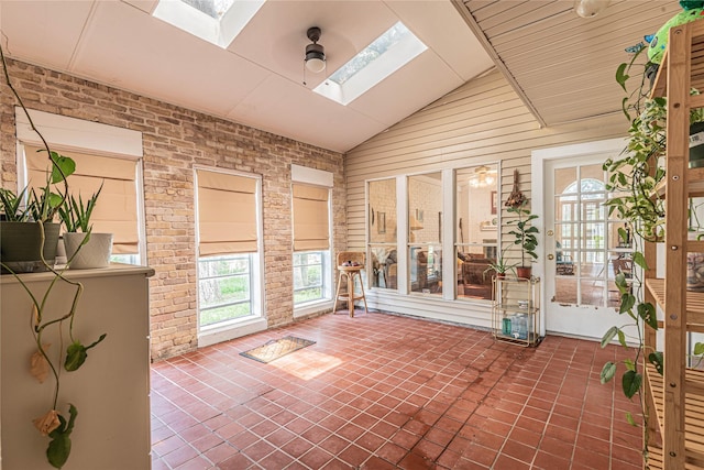 unfurnished sunroom featuring lofted ceiling with skylight