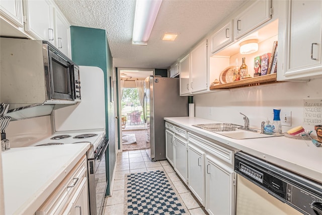 kitchen featuring a sink, a textured ceiling, electric range oven, freestanding refrigerator, and dishwashing machine