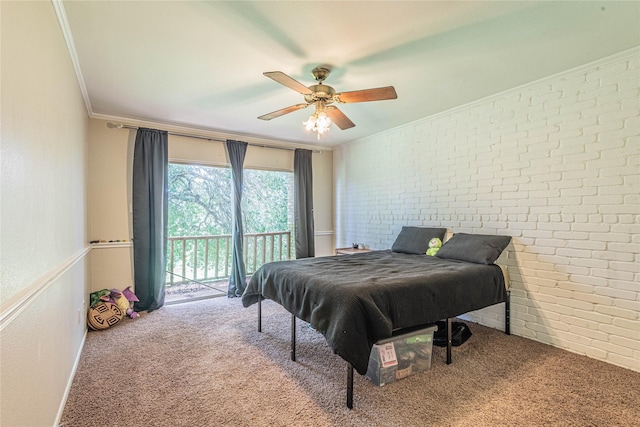 carpeted bedroom with a ceiling fan, access to exterior, crown molding, and brick wall