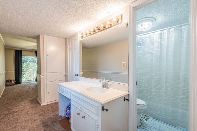 bathroom featuring a textured ceiling, vanity, and toilet