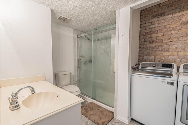 bathroom with visible vents, a shower stall, a textured ceiling, and separate washer and dryer