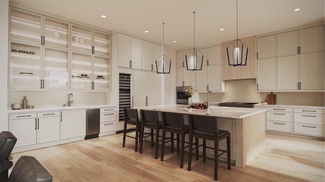 2244 N Blvd, Houston, TX 77098 - kitchen with decorative backsplash, beverage cooler, light wood-type flooring, a kitchen bar, and a kitchen island