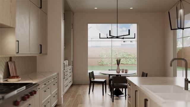 2244 N Blvd, Houston, TX 77098 - kitchen featuring a sink, light wood-style flooring, hanging light fixtures, a chandelier, and recessed lighting